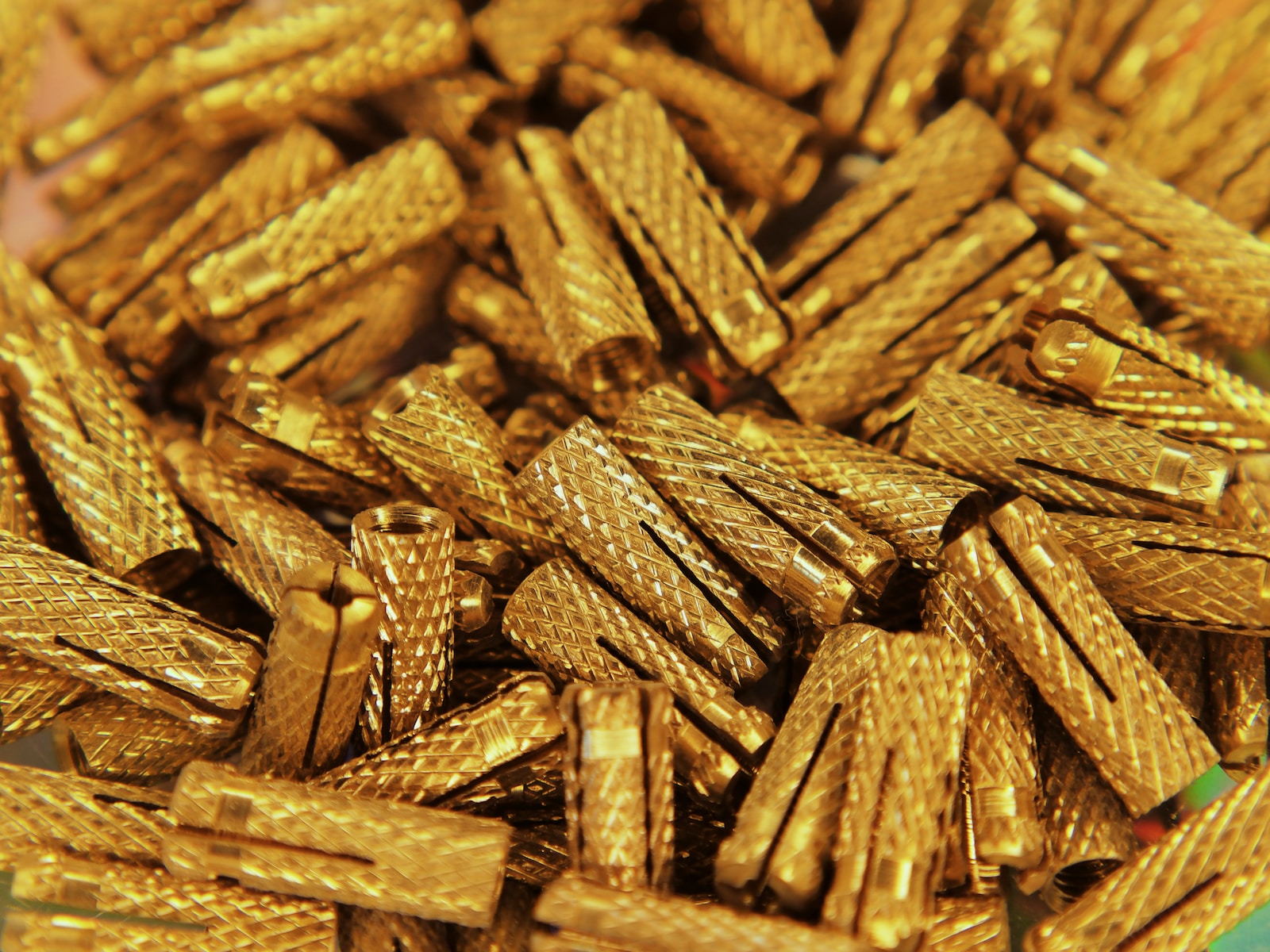 a pile of gold colored objects on a table